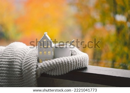 Sweet Home. Still life details in home on a wooden window. Sweater, hot tea and autumn decor. Autumn home decor. Cozy fall mood. Thanksgiving. Halloween. Cozy autumn or winter concept. Royalty-Free Stock Photo #2221041773