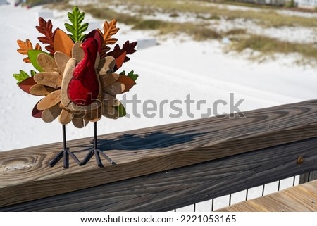 Thanksgiving turkey on a gulf coast Florida fishing pier with clear emerald water and white sandy beach 