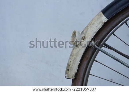 This photo shows the rusted back of a bicycle.