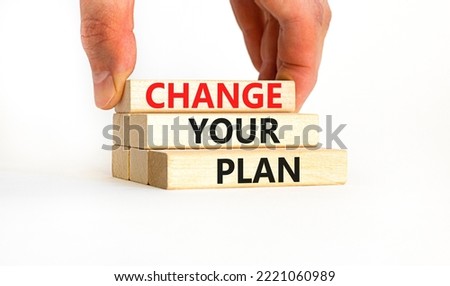 Change your plan symbol. Concept words Change your plan on wooden blocks on a beautiful white table white background. Businessman hand. Business, finacial and change your plan concept. Copy space.