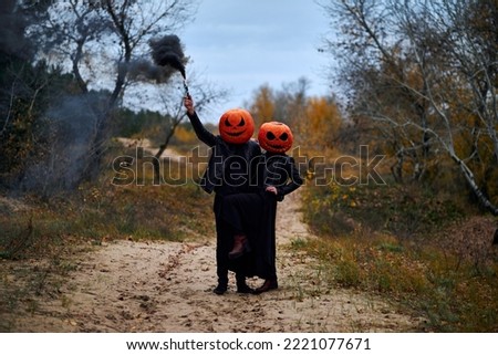 Halloween boy and girl with pumpkins on their heads
