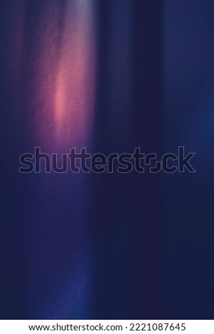 Blue and orange background. Abstract background with light and shadows over stucco wall. Moody painting style long exposure photography.