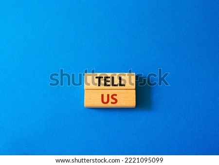 Tell us symbol. Concept words Tell us on wooden blocks. Beautiful blue background. Business and Tell us concept. Copy space.