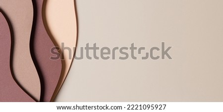 Beige colored paper texture background. Minimal paper cut style composition with layers of geometric shapes and lines in shades of brown colors. Top view Royalty-Free Stock Photo #2221095927