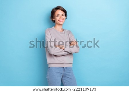 Portrait of nice cute gorgeous girl short hairdo dressed gray sweatshirt arms folded toothy smiling isolated on blue color background