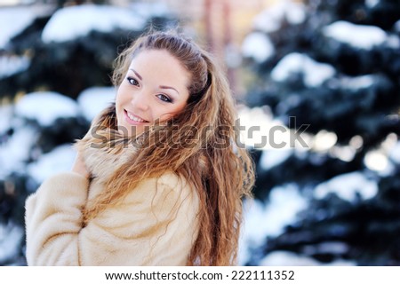 Girl playing with snow in park 