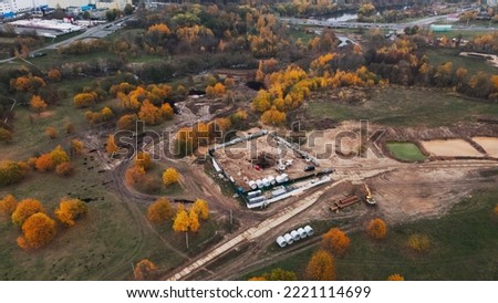 Modern urban architecture. Construction site of a new city block. Construction of multi-storey buildings. Densely populated urban area. Overcast weather. Autumn landscape. Aerial photography.