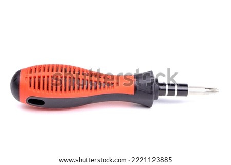 Small Screwdriver with red handle isolated on white background.