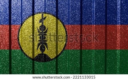 Textured flag of New Caledonia on metal wall. Colorful natural abstract geometric background with lines.