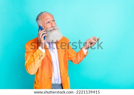 Photo of serious successful aged person speak communicate telephone isolated on turquoise color background