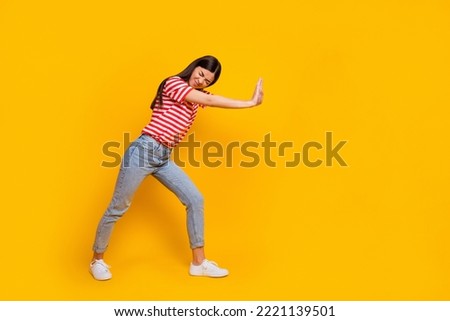 Full length profile portrait of hardworking pretty lady closed eyes arms push empty space isolated on yellow color background Royalty-Free Stock Photo #2221139501
