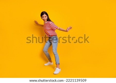 Full length photo of pretty satisfied cheerful girl dancing have fun isolated on yellow color background