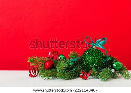 New Year Christmas tree toy, branches of a christmas tree, New Year decorations on a colored background.