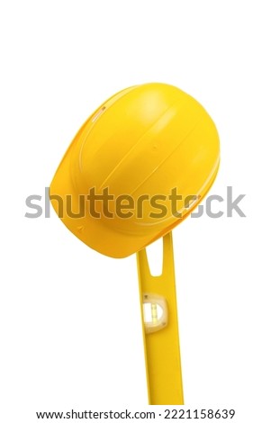 Yellow construction helmet and level on a white background. Construction concept