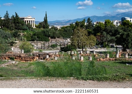 A view of the ruins at the Ancient Agora of Athens site, with the Temple of Hephaestus at the far side of the archeological site. Royalty-Free Stock Photo #2221160531