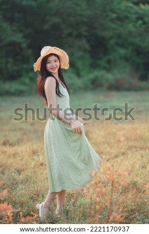 Relaxed brunette girl walking on rice fields