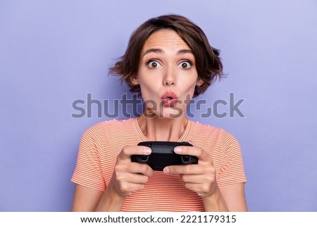 Close up photo of astonished lady big eyes having fun playstation pastime free time isolated on purple color background.