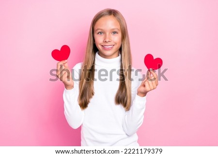 Composite collage picture of adorable positive girl arm hold small heart cards isolated on pink color background