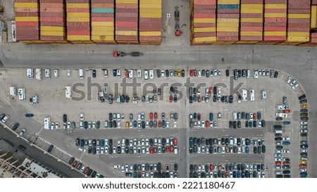 Aerial top view of parking lot with many cars from above, transportation and urban concept. Containers for the transport of goods by ship. Colors