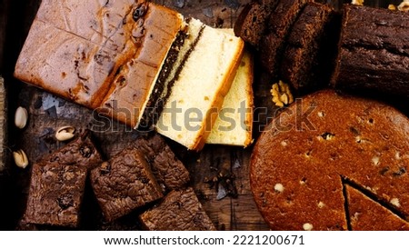 Different kinds of cakes arranged on a wooden tray