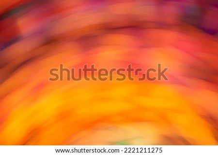 Colorful dynamic background, abstract blurred flowing design, vivid orange, yellow and purple lights in motion.