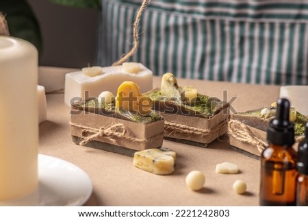 Beautiful natural handmade soap, packed in kraft paper and tied with a ribbon. Concept of an interesting hobby and useful eco friendly organic gifts.