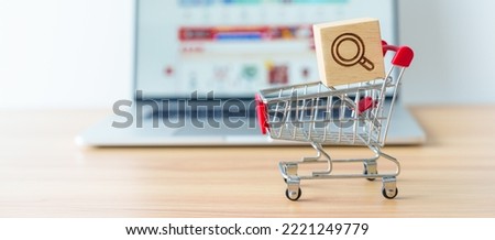 Shopping cart with Magnifying icon block and laptop computer with marketplace website, technology, ecommerce, SEO, Search Engine Optimization, Advertising, keyword and online payment concept