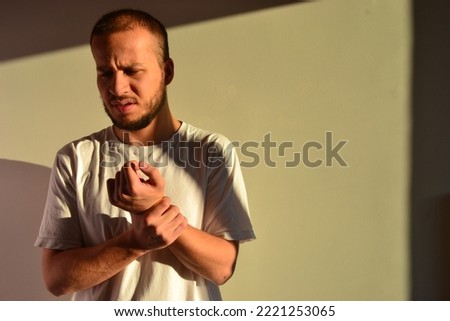 isolated white background, a man with a sore hand, suffering man 