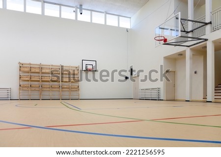 A beautiful indoor court with a hoop Royalty-Free Stock Photo #2221256595