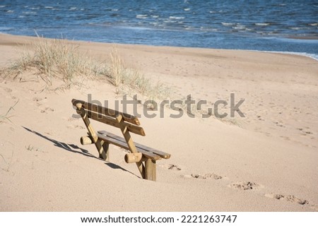 wooden bench on empty beach