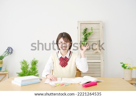 Asian high school student OK gesture at home