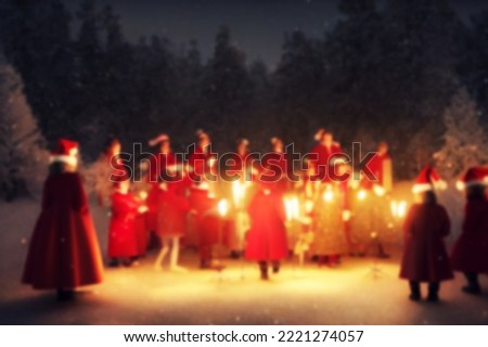 Christmas caroling or Carolers singing outside with snow.Angel group singing carol song on celebration of Christmas winter time.Angel sing to noel's children in the church light festival. blurred.
