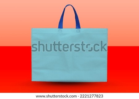 Non-Woven sky Color Bag with copy space for text and logo. Eco-friendly Shopping Bag Isolated on white background.  blue polypropylene bags. pile of tote bags of non-woven fabric