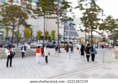Blurred view of Seoul street with modern buildings, pavements and stylish people walking. Can be used as background. De focused image of capital of south Korea.