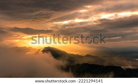 The Most Beautiful sunrise view from Pokhara with layers of the mountain on a cloudy morning.