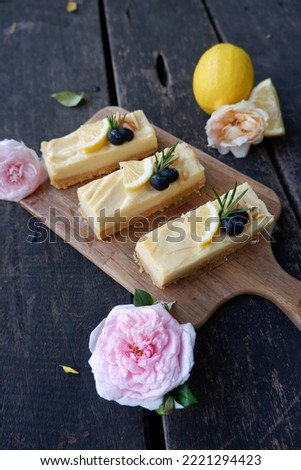 Lemon Meringue Tart is tangy and sweet. Dessert on a wooden plate with a wooden. Free space for text. The background.