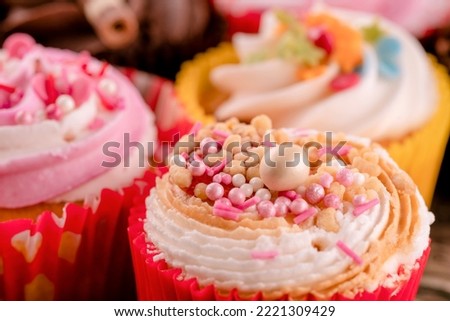 different muffins cupcakes on a wooden background high-quality photos for calendar and cards.