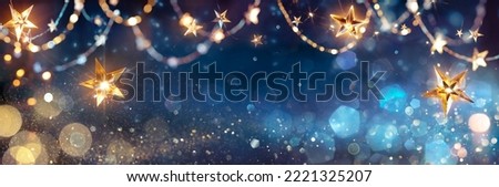 String Star Lights In Blue Defocused Abstract Background With Glittering And Bokeh Royalty-Free Stock Photo #2221325207