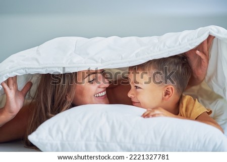 Young mother with 4 years old son in bed