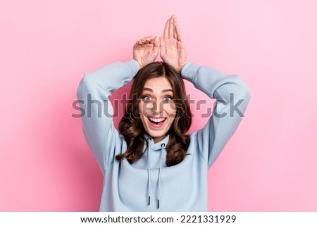 Photo of cheerful carefree person toothy smile hands make bunny ears isolated on pink color background