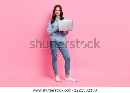 Full length photo of cheerful pretty person hold wireless netbook isolated on pink color background