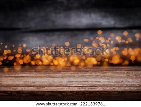 Background with wooden table and christmas lights illumination with bokeh