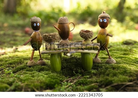 Cute figures made of natural materials on green moss outdoors