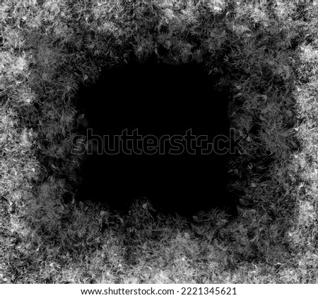 A frame of a frosty pattern  on a black background. A frame with an abstract ice structure allows you to apply or add a frost effect. Frost on the glass, freezing effect Royalty-Free Stock Photo #2221345621