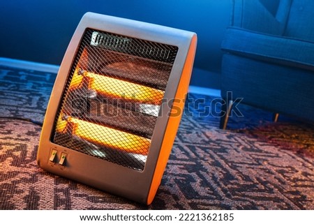 Modern electric infrared heater in the living room Royalty-Free Stock Photo #2221362185