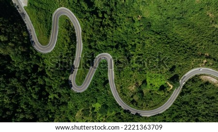 aerial view ROAD No.1081 of winding mountain road between Pua Ddistric, Nan Province, Thailand is highlignt that tourist like to take pictures of because of the beauty of the road. Royalty-Free Stock Photo #2221363709
