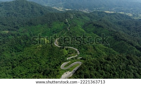 aerial view ROAD No.1081 of winding mountain road between Pua Ddistric, Nan Province, Thailand is highlignt that tourist like to take pictures of because of the beauty of the road.