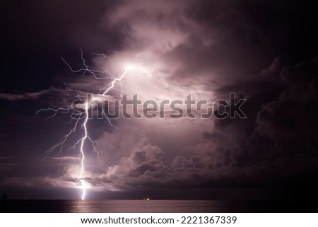 A scenic view of beautiful lightning over the sea in Darwin