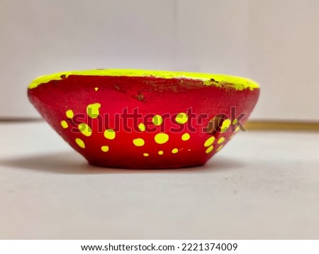 Picture of lit diya lamp made of clay used on a white background for decoration of houses on the festival of Diwali. Deepavli or Dipavali celebration.
