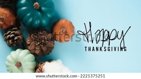 Top view of pumpkins and pinecones on blue thanksgiving background for holiday card.